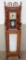 Ornate cabinet with inset Waterbury clock with portrait front