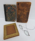 Three early books, board and period eye glasses