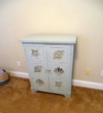 Light blue/green chest with shell cutouts. 16
