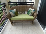 Outdoor sturdy plastic wicker glider w/cushion, pillows and 2 pillows, plus cover for glider.
