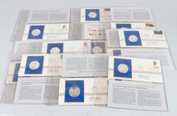 12- SILVER MEDALS w/ FIRST DAY ISSUES 9.5ozt