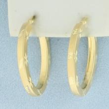 Diamond Cut Oval Hoop Earrings In 14k Yellow Gold