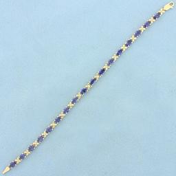 Aaa Tanzanite Flower Design Line Bracelet In 14k Yellow Gold