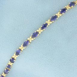 Aaa Tanzanite Flower Design Line Bracelet In 14k Yellow Gold