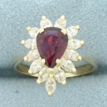 Pear Cut Ruby And Diamond Halo Ring In 14k Yellow Gold