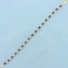 Aaa Tanzanite Flower Design Line Bracelet In 14k Yellow Gold