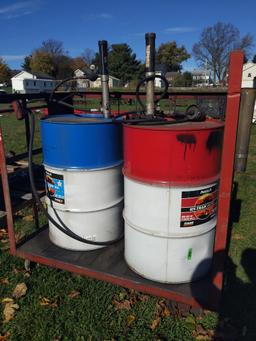 Pair of 55 gal oil drums on caddy