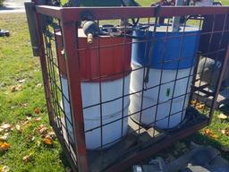 Pair of 55 gal oil drums on caddy