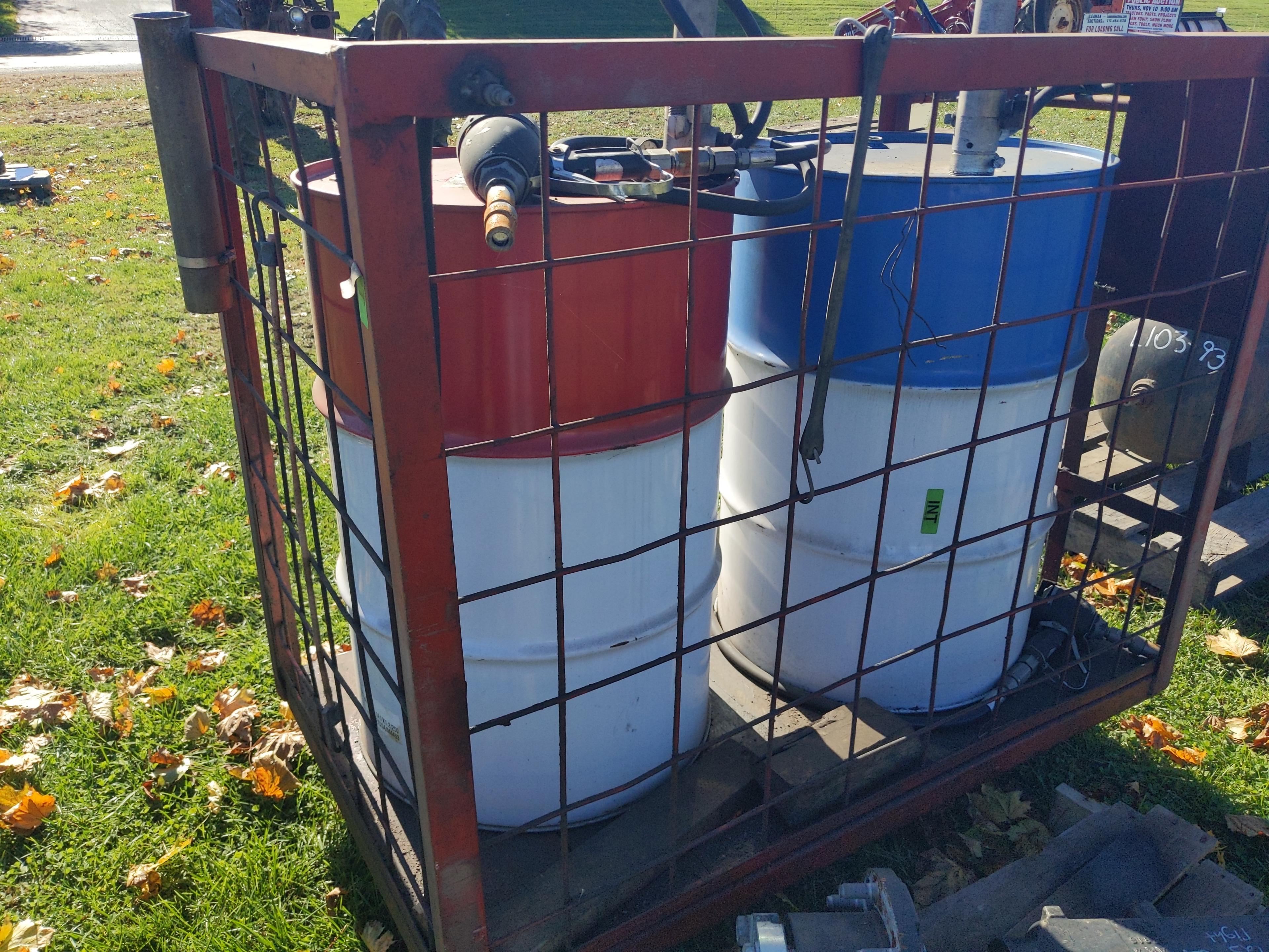 Pair of 55 gal oil drums on caddy