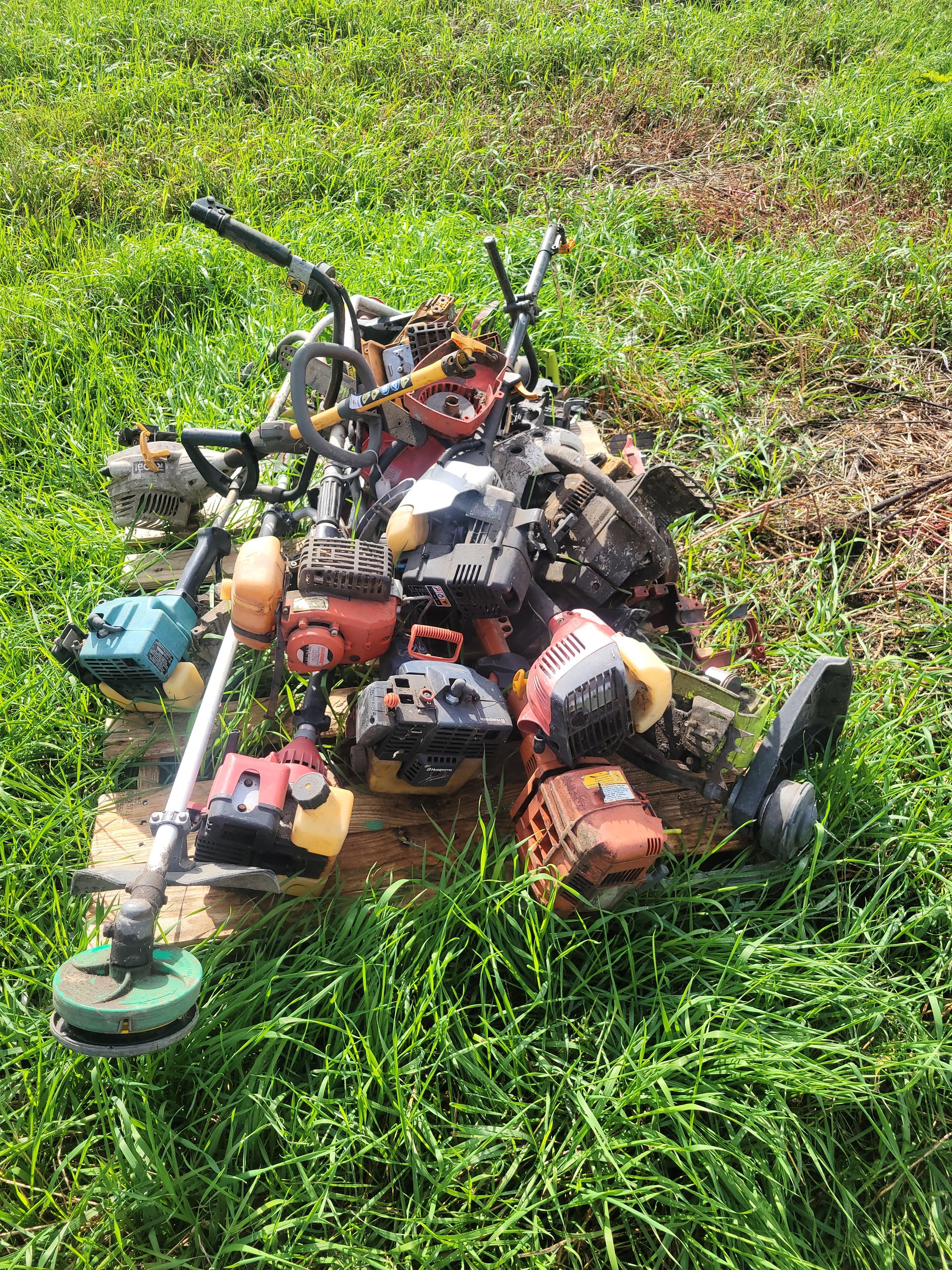 pallet of parts weedeaters and chainsaws