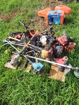 pallet of parts weedeaters and chainsaws
