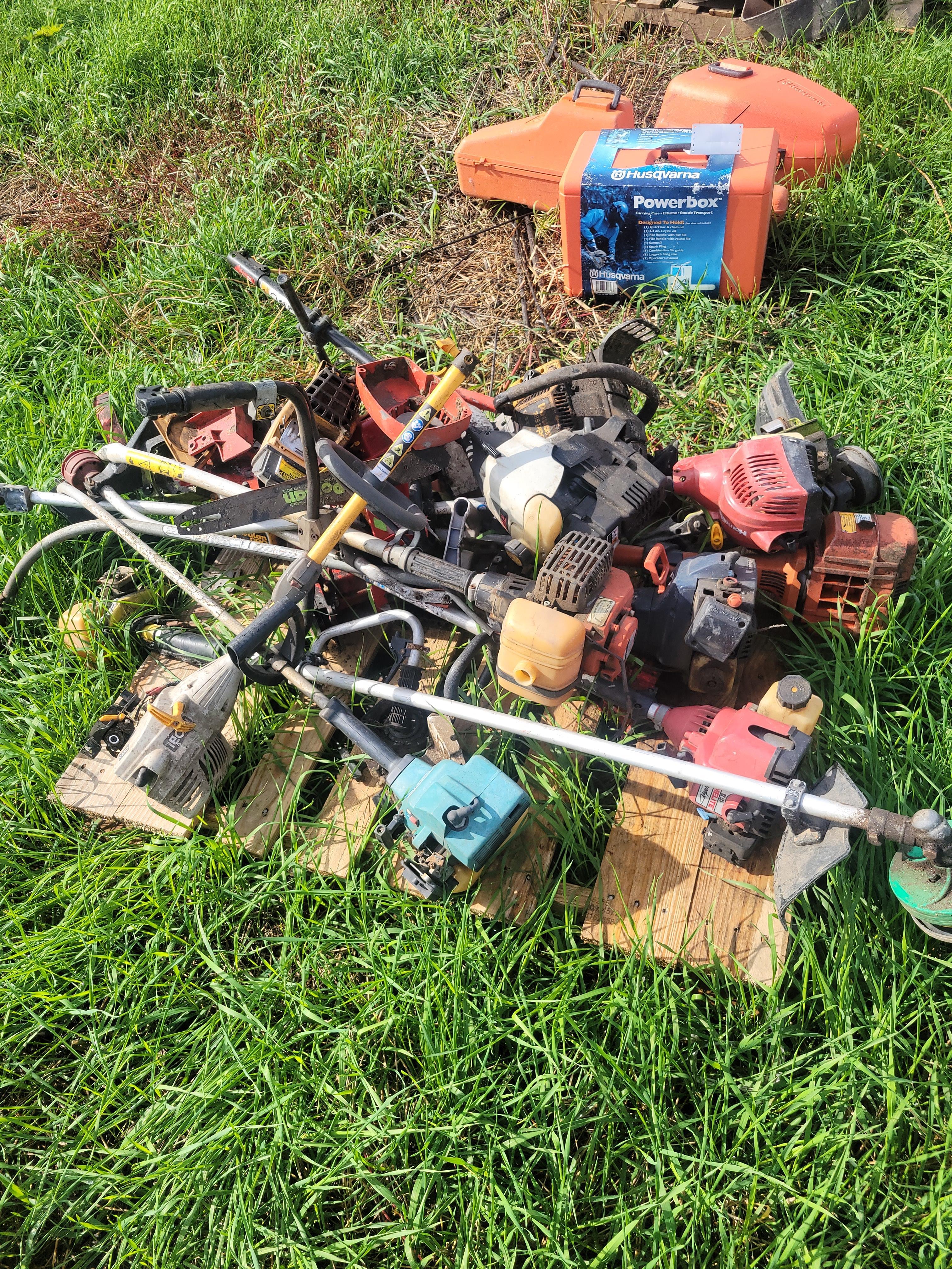 pallet of parts weedeaters and chainsaws