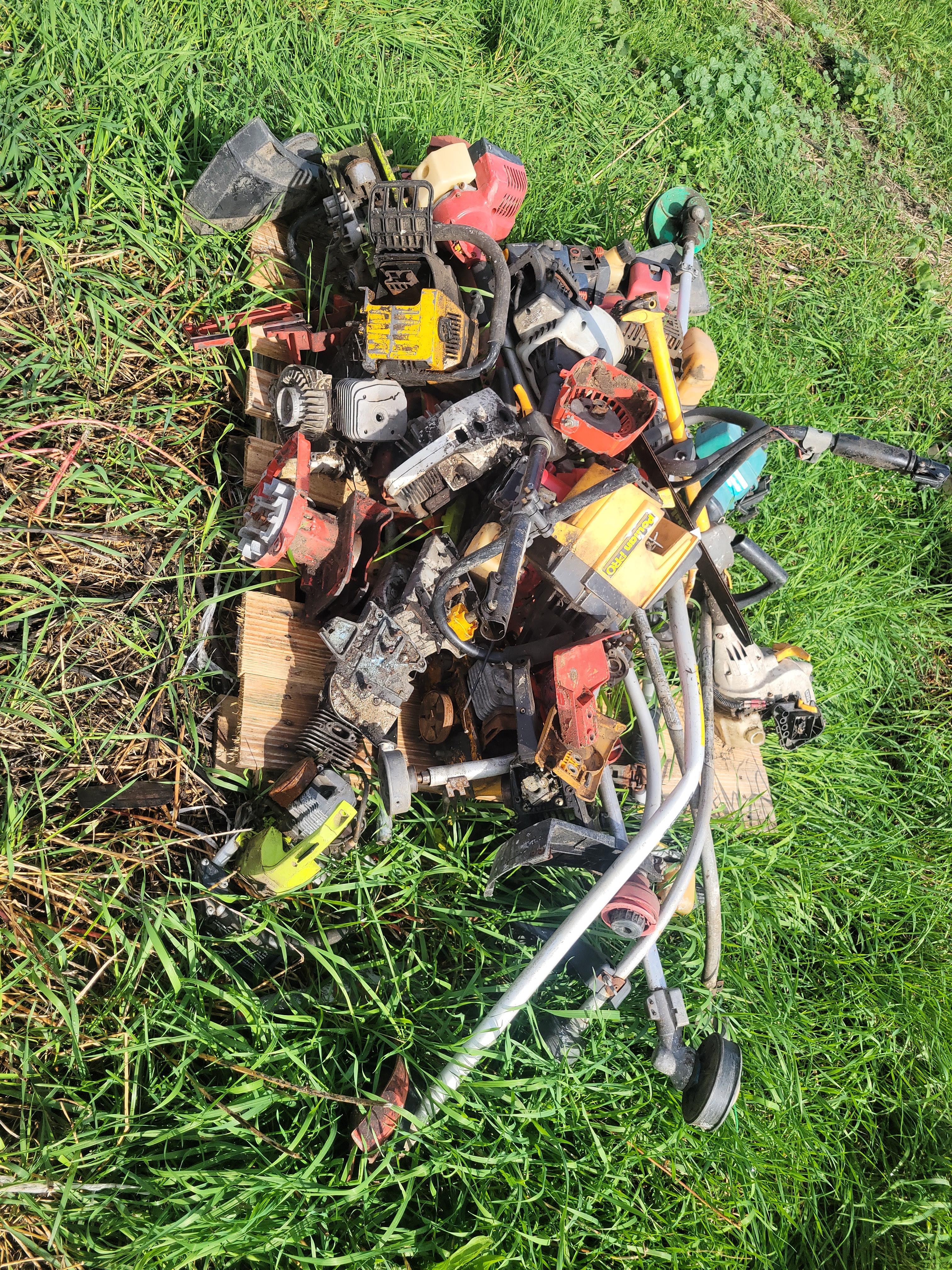 pallet of parts weedeaters and chainsaws