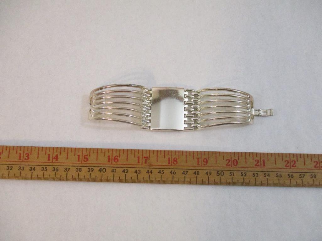 Two Silver Tone Bracelets including clamshell with rhinestones, 4 oz