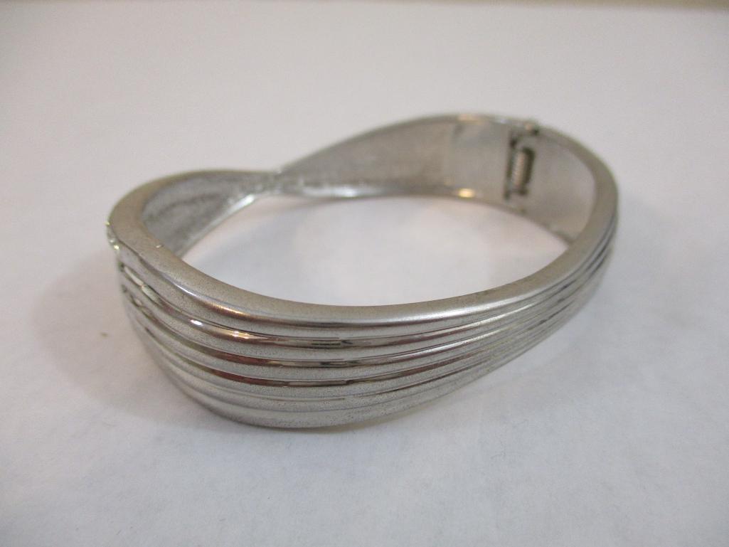Two Silver Tone Bracelets including clamshell with rhinestones, 4 oz