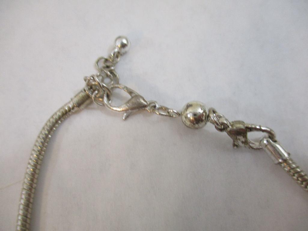 Three Silver Tone Bracelets including two-strand with beads, charms and more, 3 oz