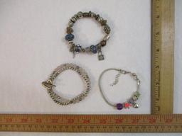 Three Silver Tone Bracelets including two-strand with beads, charms and more, 3 oz