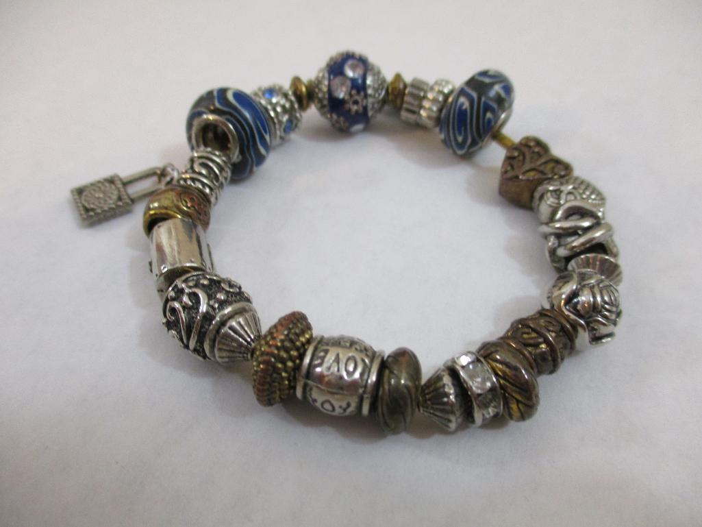 Three Silver Tone Bracelets including two-strand with beads, charms and more, 3 oz
