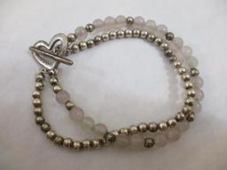 Three Silver Tone Bracelets including two-strand with beads, charms and more, 3 oz