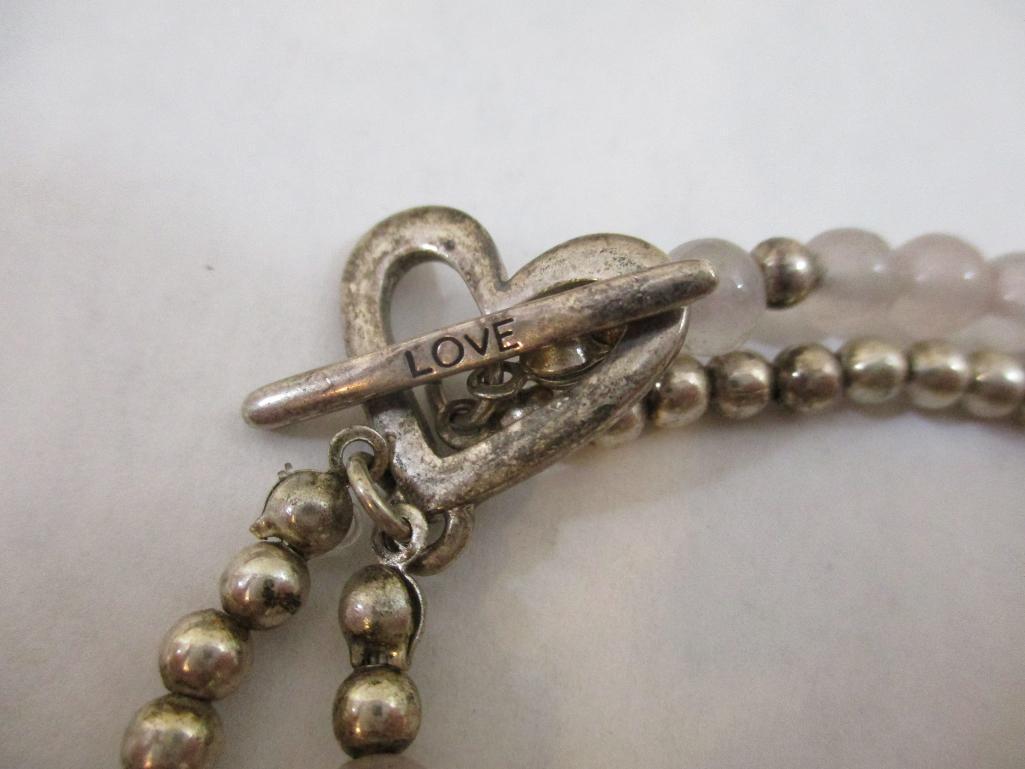 Three Silver Tone Bracelets including two-strand with beads, charms and more, 3 oz