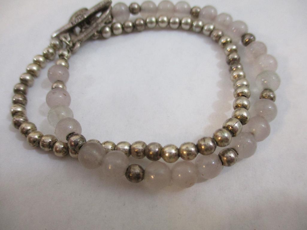 Three Silver Tone Bracelets including two-strand with beads, charms and more, 3 oz