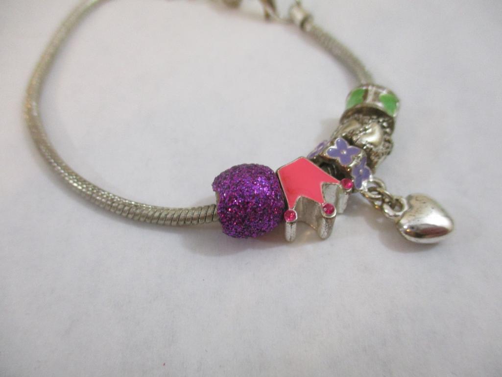Three Silver Tone Bracelets including two-strand with beads, charms and more, 3 oz
