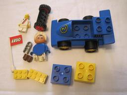 Assorted Lego Pieces including racecar, flag, figures and blocks, 4 oz