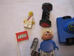 Assorted Lego Pieces including racecar, flag, figures and blocks, 4 oz