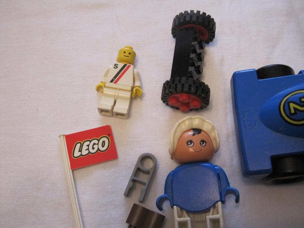 Assorted Lego Pieces including racecar, flag, figures and blocks, 4 oz