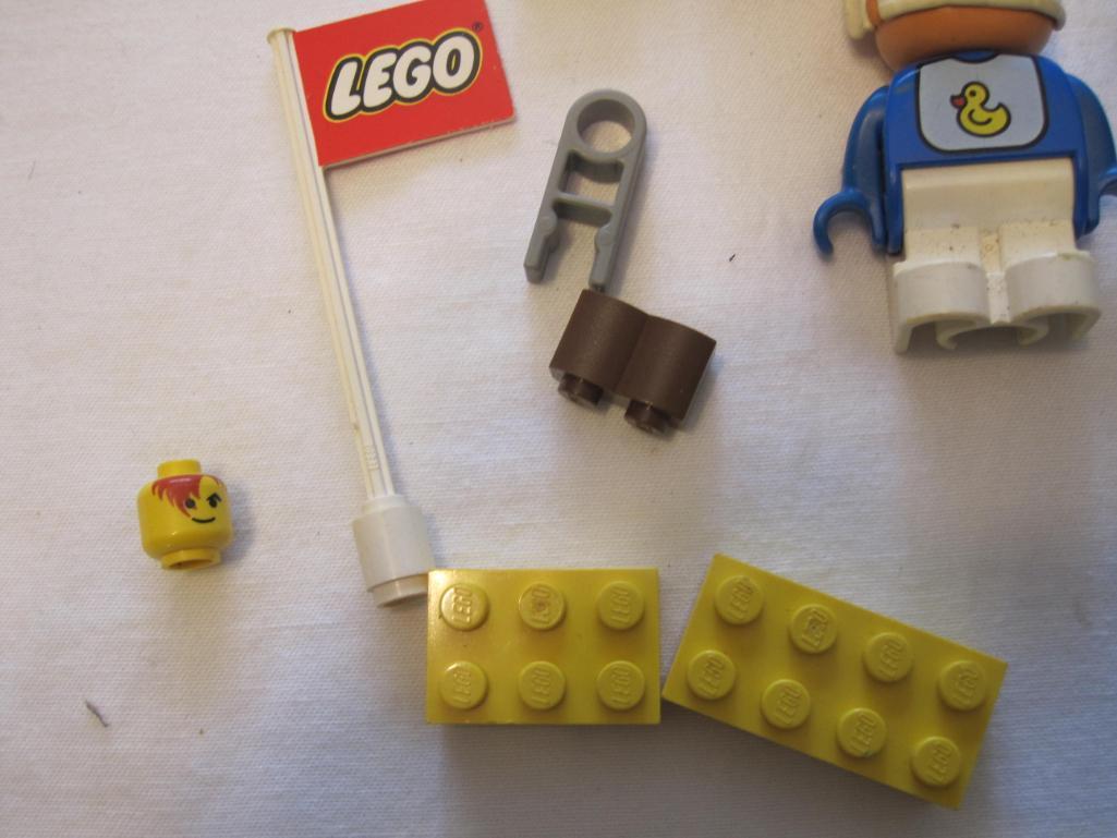 Assorted Lego Pieces including racecar, flag, figures and blocks, 4 oz