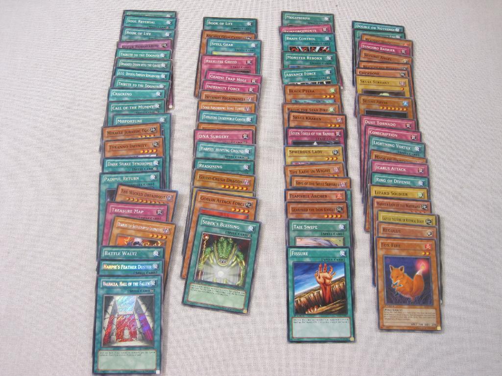 Assorted Yu-Gi-Oh Trading Cards including foil The Wicked Dreadroot, foil Treasure Map, foil