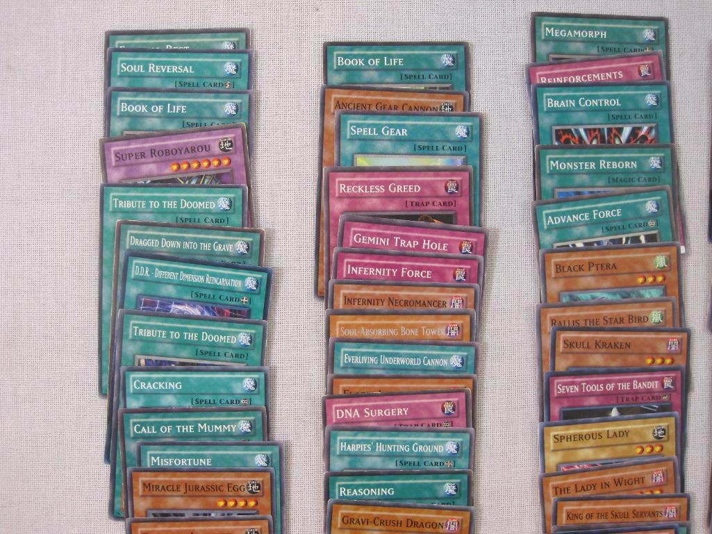 Assorted Yu-Gi-Oh Trading Cards including foil The Wicked Dreadroot, foil Treasure Map, foil