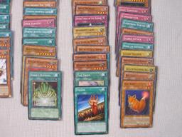 Assorted Yu-Gi-Oh Trading Cards including foil The Wicked Dreadroot, foil Treasure Map, foil