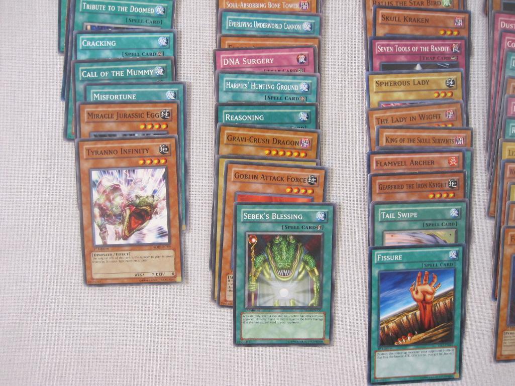 Assorted Yu-Gi-Oh Trading Cards including foil The Wicked Dreadroot, foil Treasure Map, foil