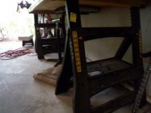 Set of Plastic Adjustable Height Saw Horses Under the Work Bench