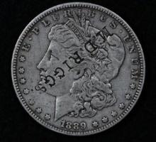 1889 Silver Morgan dollar, counter stamped "M.D. Riggs" on obverse.