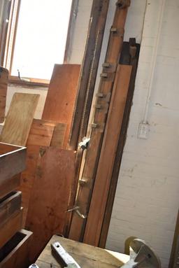 STACK OF WOODEN CRATES AND DRAWERS WITH WOOD AGAINST WALL