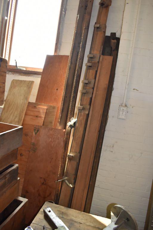 STACK OF WOODEN CRATES AND DRAWERS WITH WOOD AGAINST WALL