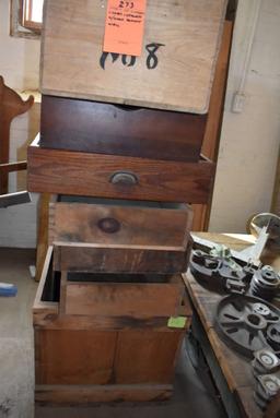 STACK OF WOODEN CRATES AND DRAWERS WITH WOOD AGAINST WALL