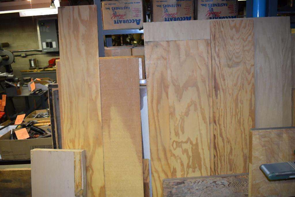 ASSORTED LUMBER LEANING AGAINST SHELVES