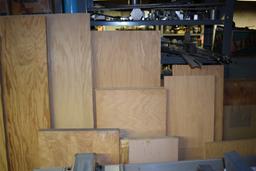 ASSORTED LUMBER LEANING AGAINST SHELVES