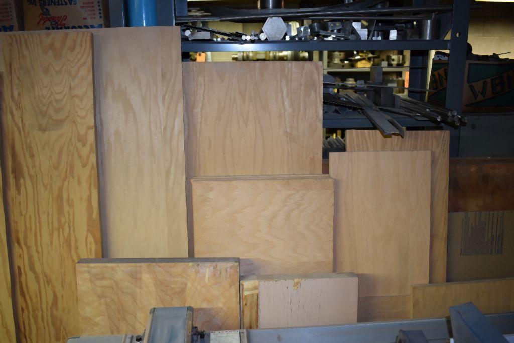 ASSORTED LUMBER LEANING AGAINST SHELVES