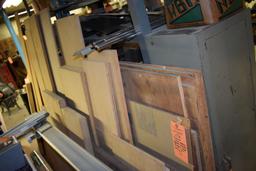 ASSORTED LUMBER LEANING AGAINST SHELVES