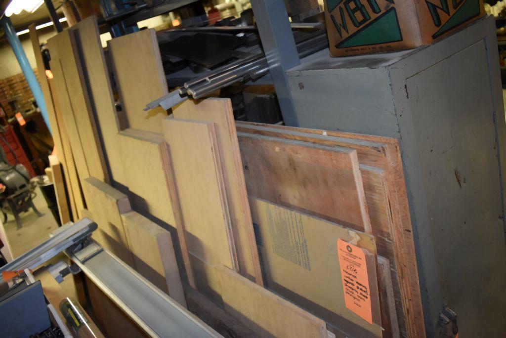 ASSORTED LUMBER LEANING AGAINST SHELVES