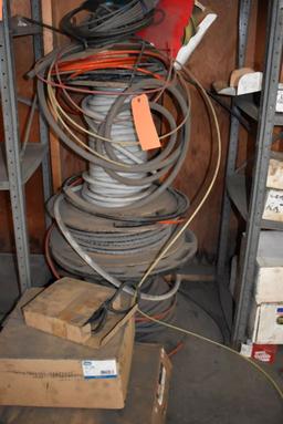 BOXES AND ROLLS OF ASSORTED TUBING AND AIR HOSE ON FLOOR