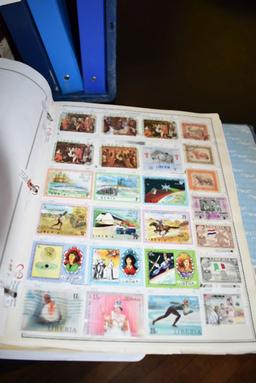 THOUSANDS OF FOREIGN STAMPS - (9) BINDERS; LAOS