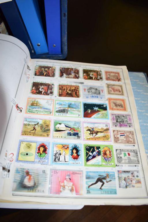 THOUSANDS OF FOREIGN STAMPS - (9) BINDERS; LAOS