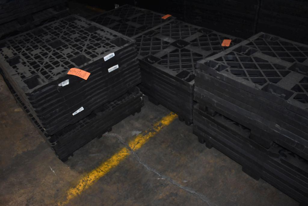 (4) STACKS OF NESTING PLASTIC PALLETS ON FLOOR,