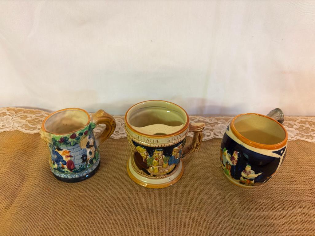 GERMAN MUSTACHE STEIN 4"D X 4 1/8"H AND (2) MISC MUGS