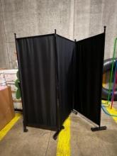 PORTABLE BLACK NYLON DIVIDER WALL ON WHEELS, TRI-FOLD, EACH PANEL 28" X 64"H, W/FRAME 69-1/2" H X